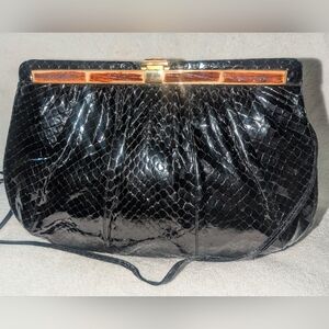 Judith Leiber Black Snakeskin Clutch with Resin Bone Accent.